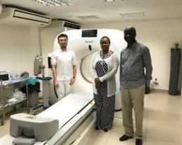 Engineers discussing equipment with hospital staff in a CT room